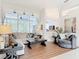 Bright living room featuring large windows, neutral colors, and comfortable seating area at 456 Sea Duck Dr, Daytona Beach, FL 32119