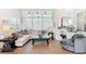 Bright living room featuring large windows, neutral colors, and comfortable seating area at 456 Sea Duck Dr, Daytona Beach, FL 32119