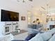 Living room with TV, console table, plush seating, and open layout to kitchen at 456 Sea Duck Dr, Daytona Beach, FL 32119