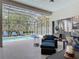 Relaxing screened-in pool area with lounge chairs, adjacent to the stylish covered lanai at 456 Sea Duck Dr, Daytona Beach, FL 32119