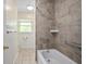 Bathroom featuring a shower-tub combo and tile flooring at 502 W Hogle Ave, Deland, FL 32720