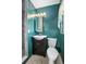 Bathroom featuring dark blue walls, a sink, and toilet at 502 W Hogle Ave, Deland, FL 32720