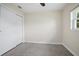 Clean bedroom with neutral carpet, a closet, and a window bringing in natural light at 502 W Hogle Ave, Deland, FL 32720
