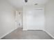 This bedroom includes neutral walls, carpet flooring, and closet access at 502 W Hogle Ave, Deland, FL 32720