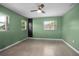 Bedroom featuring green walls, carpet flooring, and a window at 502 W Hogle Ave, Deland, FL 32720