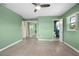 This bedroom includes green walls and carpet flooring at 502 W Hogle Ave, Deland, FL 32720