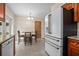 Cozy dining area with stylish table and chairs, adjacent to a modern white refrigerator at 502 W Hogle Ave, Deland, FL 32720