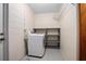 Clean and bright laundry room with a dryer, shelving and ample space for storage at 502 W Hogle Ave, Deland, FL 32720