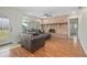 Cozy living room featuring a classic brick fireplace, hardwood floors, and ample natural light at 502 W Hogle Ave, Deland, FL 32720