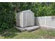 Shed on a wood platform surrounded by landscaping with garden edging, offering additional storage space at 502 W Hogle Ave, Deland, FL 32720