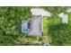 Aerial view of home with a private pool, surrounded by lush greenery and mature trees at 505 Black Ironwood Dr, Deland, FL 32724