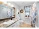 Bathroom featuring a wood-trimmed mirror, granite countertop, and a seashell-themed wreath at 505 Black Ironwood Dr, Deland, FL 32724