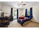 Comfortable bedroom with natural light, a ceiling fan, a cozy bed, and a dedicated workspace at 505 Black Ironwood Dr, Deland, FL 32724