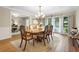Dining room featuring a chandelier, large windows with curtains, and natural light at 505 Black Ironwood Dr, Deland, FL 32724
