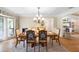 Elegant dining room with decorative chairs, chandelier, and tray ceiling at 505 Black Ironwood Dr, Deland, FL 32724