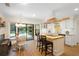 Open kitchen featuring white cabinets, a wood island, a stylish range hood, and views of the outdoor patio at 505 Black Ironwood Dr, Deland, FL 32724
