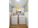 Laundry room featuring Maytag washer and dryer with yellow-patterned wallpaper above at 505 Black Ironwood Dr, Deland, FL 32724