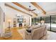 Cozy living room with vaulted ceiling, wood beams, fireplace and pool views at 505 Black Ironwood Dr, Deland, FL 32724