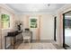 Office featuring neutral walls, a desk with a printer, and a view of the outdoor pool at 505 Black Ironwood Dr, Deland, FL 32724