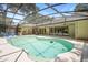Large screened-in pool area with lots of entertaining space and a glimpse of the home's exterior at 505 Black Ironwood Dr, Deland, FL 32724