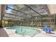 Screened-in pool surrounded by lush greenery and complete with blue Adirondack chairs for relaxation at 505 Black Ironwood Dr, Deland, FL 32724