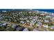 A charming coastal community with colorful homes, lush trees, and a pristine beach in the background at 505 Wisteria Rd, Daytona Beach, FL 32118