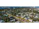 An aerial view showcasing a vibrant neighborhood with colorful homes near a bridge and waterway at 505 Wisteria Rd, Daytona Beach, FL 32118