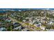 An aerial view showcasing a vibrant neighborhood with colorful homes near a bridge and waterway at 505 Wisteria Rd, Daytona Beach, FL 32118