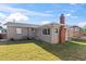 The backyard features a chimney and newly cut grass at 505 Wisteria Rd, Daytona Beach, FL 32118