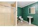 This bathroom is painted green and has a shower, toilet, and vanity sink at 505 Wisteria Rd, Daytona Beach, FL 32118