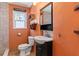 Charming bathroom featuring modern vanity, toilet, decor, and walk-in shower with tile surround at 505 Wisteria Rd, Daytona Beach, FL 32118