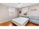 This comfortable bedroom features hardwood floors, modern ceiling fan, and bright windows at 505 Wisteria Rd, Daytona Beach, FL 32118