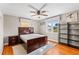 Well-lit bedroom with wood flooring, neutral walls, windows, ceiling fan, and a modern furniture set at 505 Wisteria Rd, Daytona Beach, FL 32118