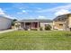Charming home with a well-manicured lawn and a vibrant red front door at 505 Wisteria Rd, Daytona Beach, FL 32118