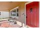Inviting front porch featuring tiled flooring, number '505', and a red front door at 505 Wisteria Rd, Daytona Beach, FL 32118