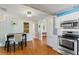 The kitchen and dining area showcase wood floors, stainless appliances, and neutral walls and cabinetry at 505 Wisteria Rd, Daytona Beach, FL 32118