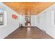 Large space featuring unique wood ceiling and flooring, white walls, and doors to the rest of the house at 505 Wisteria Rd, Daytona Beach, FL 32118
