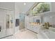 Bright bathroom featuring dual sinks, a glass shower and soaking tub at 519 Donaldson Dr, Debary, FL 32713