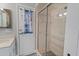 A bright bathroom features a glass-enclosed shower and a vanity with beach-themed accessories at 519 Donaldson Dr, Debary, FL 32713