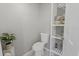 Neat bathroom features a new toilet, bright shelves and a plant at 519 Donaldson Dr, Debary, FL 32713