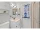 Bathroom with white vanity, mirrored medicine cabinet, and a charming beach themed shower curtain at 519 Donaldson Dr, Debary, FL 32713