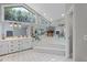 Bright bathroom featuring dual sinks, a soaking tub, and mirrored accents at 519 Donaldson Dr, Debary, FL 32713