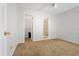 A bright bedroom with neutral carpet, white walls, and access to a closet and bathroom at 519 Donaldson Dr, Debary, FL 32713
