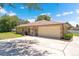A suburban house with a two-car garage and an array of solar panels on the roof at 519 Donaldson Dr, Debary, FL 32713