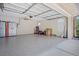 Clean and well-lit garage featuring epoxy flooring, a ceiling fan, and ample storage space, perfect for organization at 519 Donaldson Dr, Debary, FL 32713