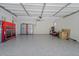 Spacious garage with epoxy flooring, providing ample storage and workspace with neat and organized features at 519 Donaldson Dr, Debary, FL 32713