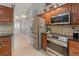 Open kitchen with stainless steel appliances and granite countertops, looking toward entryway at 519 Donaldson Dr, Debary, FL 32713
