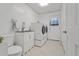 Clean laundry area with tiled floors, modern washer and dryer, sink, and toilet for added convenience at 519 Donaldson Dr, Debary, FL 32713