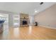 Bright living room with hardwood floors and brick fireplace with access to the pool area at 519 Donaldson Dr, Debary, FL 32713
