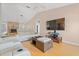 Open-concept living room with ceiling fan, cozy seating, fireplace and large tv at 519 Donaldson Dr, Debary, FL 32713